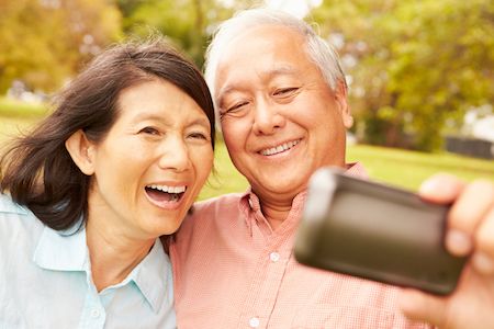 couple with dentures taking a selfie