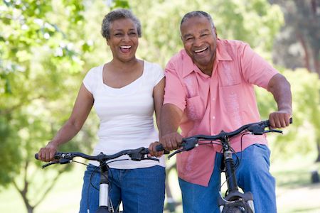 couple smiling while riding bikes together