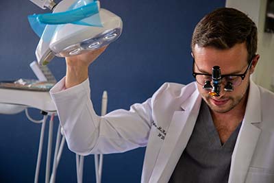 Dr. Dylan McKnight adjusting his dental technology
