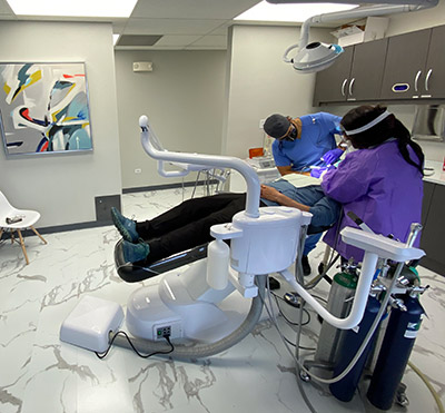 dentist giving patient dental implants at Westminster Dental Care